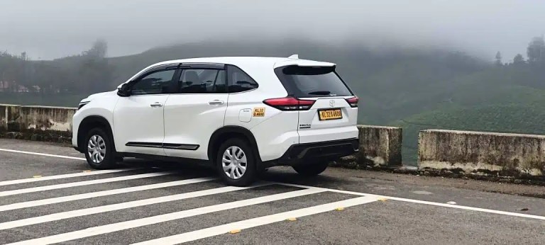 Kerala Taxis Hycross driving on Munnar mountain road
