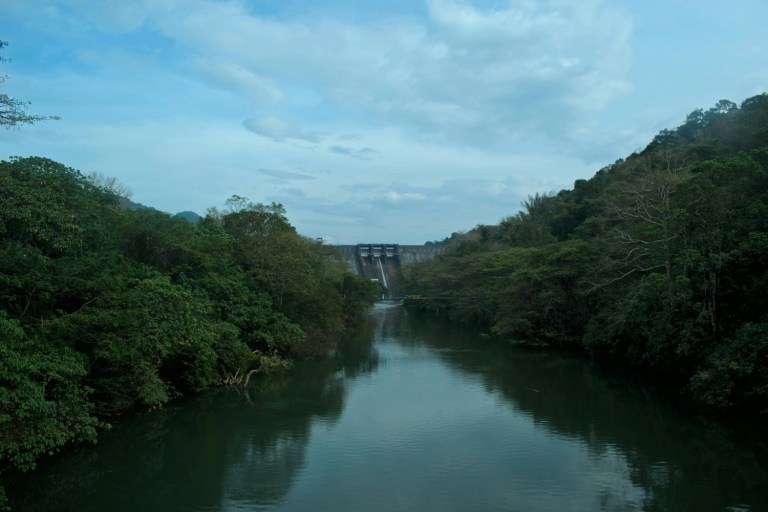 Scenic view of Thenmala Dam and reservoir surrounded by forests in Kollam Kerala