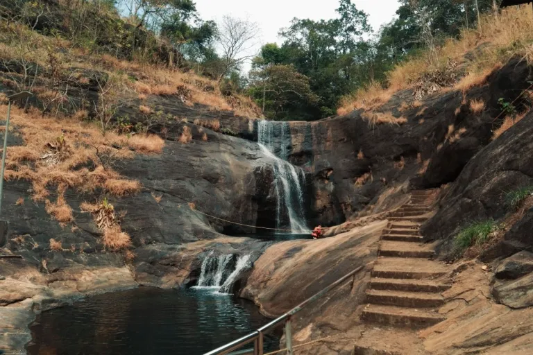 Natural rock pools and cascading waters at Ezharakund Waterfalls