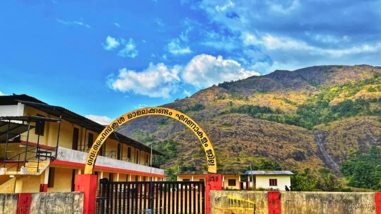 Mamalakandam school with Elamplassery Waterfall and mountain backdrop